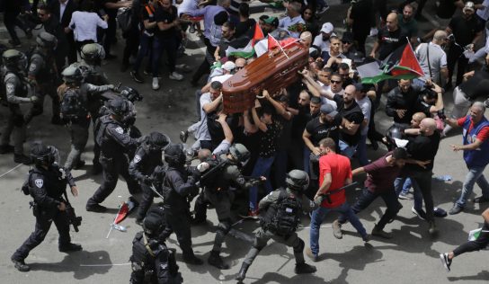 Palestinian flag is raised in Jerusalem as American journalist is laid to rest